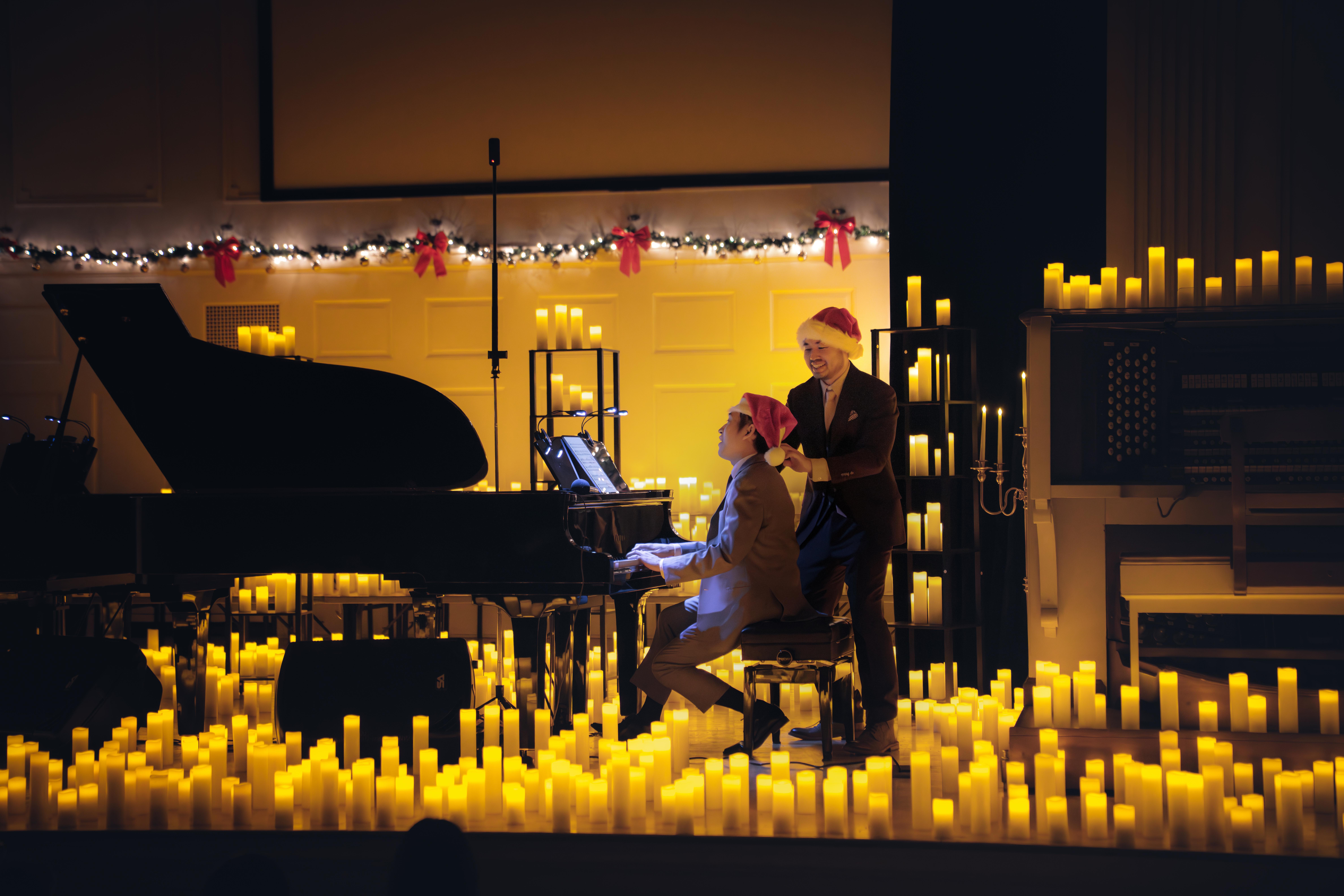 Jimmy Liu and Kevin Lee Sun on stage among candlelight